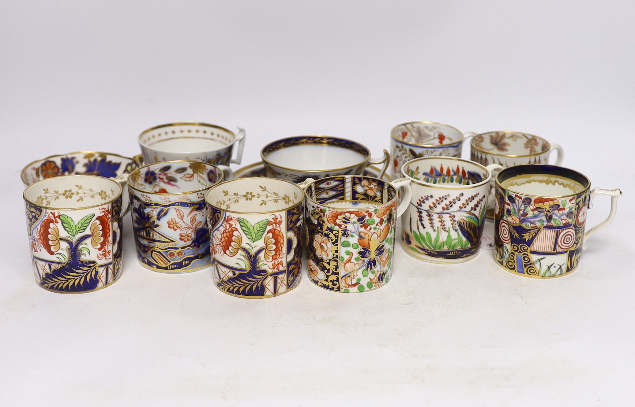 Eleven 1800-1820 English porcelain coffee cans and tea cups, including Imari pattern examples, one with matching saucer